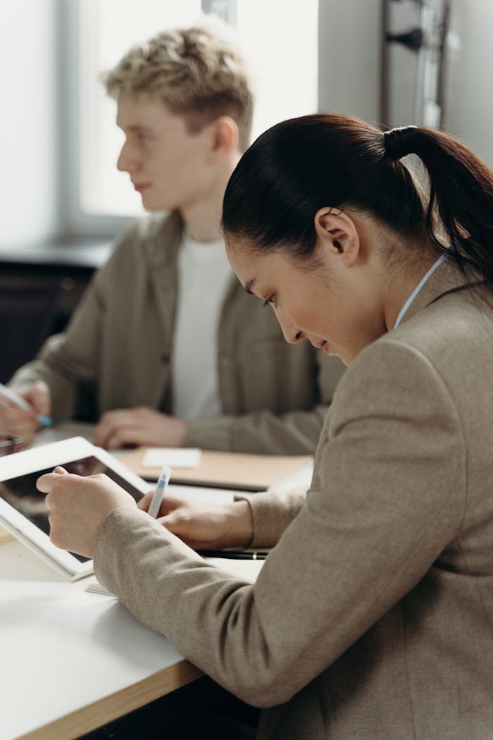 Young professionals collaborating in a modern office, focusing on teamwork and project management.
